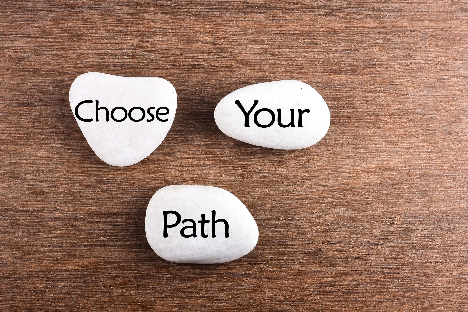 White stones with Choose your path word on wooden background White stones with Choose your path word on wooden background